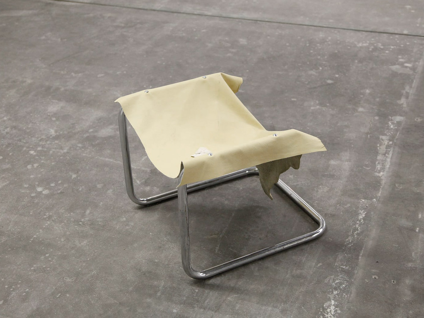Cantilever chair with nicotine-yellow leather seat that hangs down towards the back