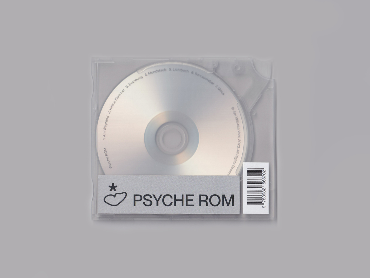A scan of a compact disc in a transparent ejector case with a sticker that reads Psyche ROM nect to an icon showing a butterfly's wing topped by a star.