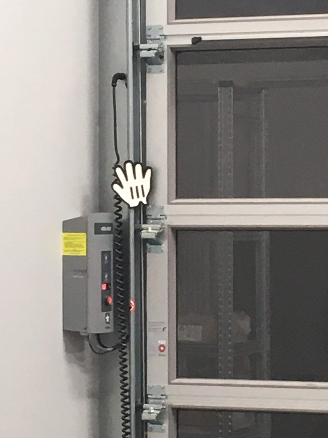 An upscaled version of the cursor:grab value, attached to the mechanism of a roller shutter.